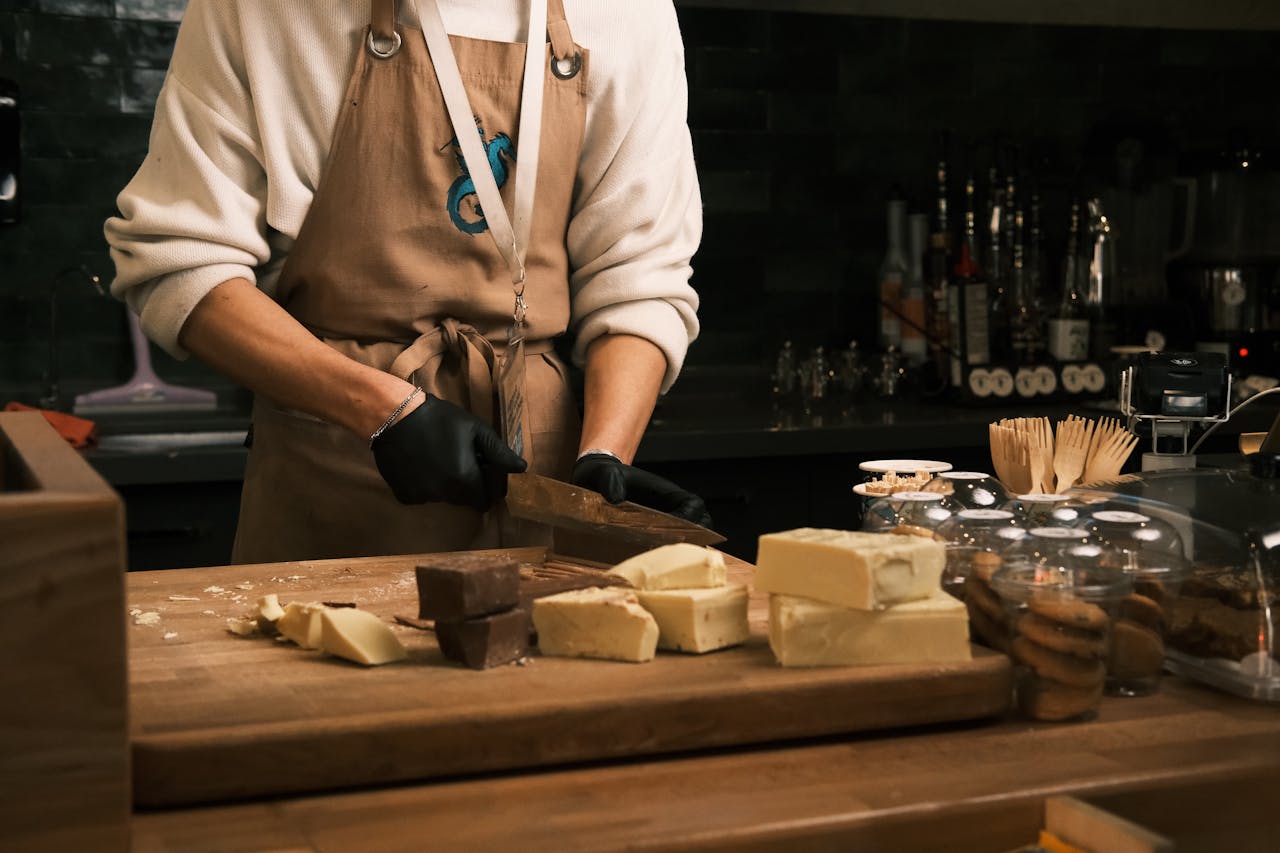 Home Barista slicing assorted gourmet chocolates in a cozy Konya café setting.